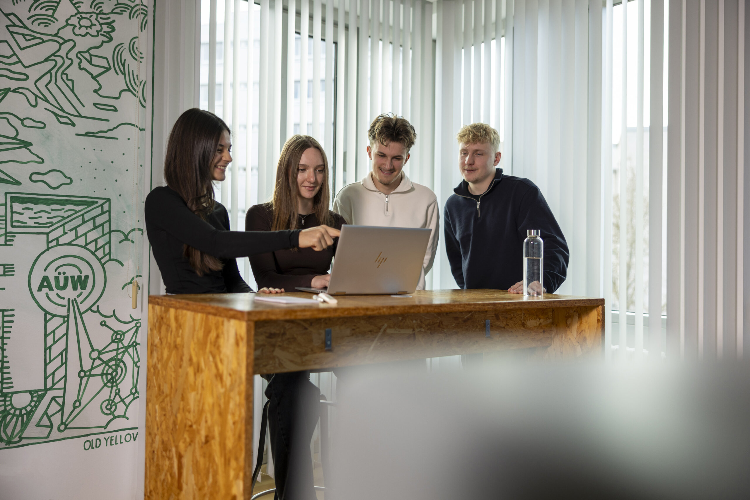 Gruppe Auszubildender Industriekaufleute am Laptop